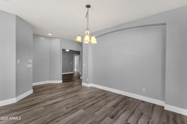 21616 E Calle De Flores, Queen Creek, AZ 85142 - unfurnished dining area with baseboards, recessed lighting, wood finished floors, and an inviting chandelier