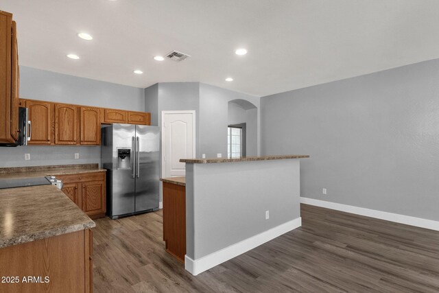 21616 E Calle De Flores, Queen Creek, AZ 85142 - kitchen with arched walkways, stainless steel fridge with ice dispenser, a center island, visible vents, and dark wood-type flooring