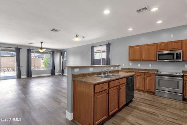 21616 E Calle De Flores, Queen Creek, AZ 85142 - kitchen featuring a sink, visible vents, stainless steel appliances, wood finished floors, and a center island with sink