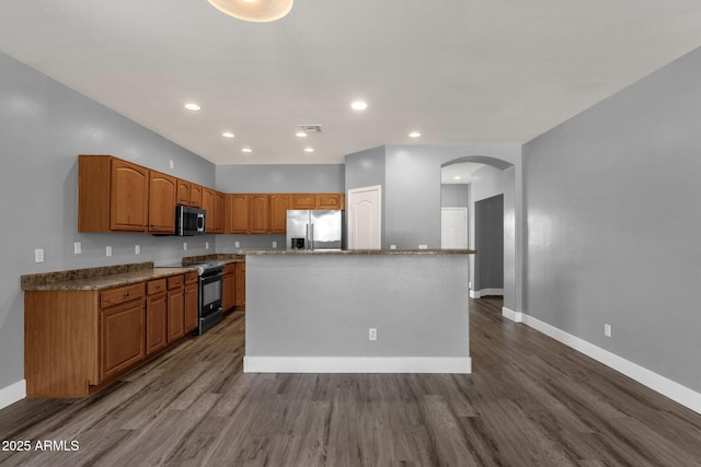 21616 E Calle De Flores, Queen Creek, AZ 85142 - kitchen featuring baseboards, arched walkways, appliances with stainless steel finishes, and dark wood-type flooring