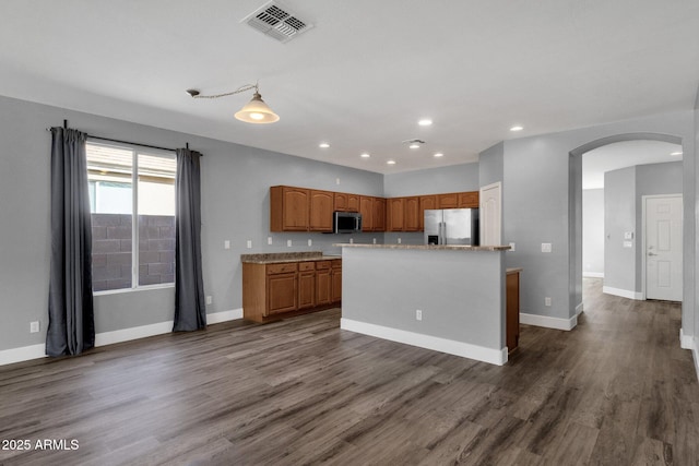 21616 E Calle De Flores, Queen Creek, AZ 85142 - kitchen with dark wood finished floors, visible vents, arched walkways, and appliances with stainless steel finishes