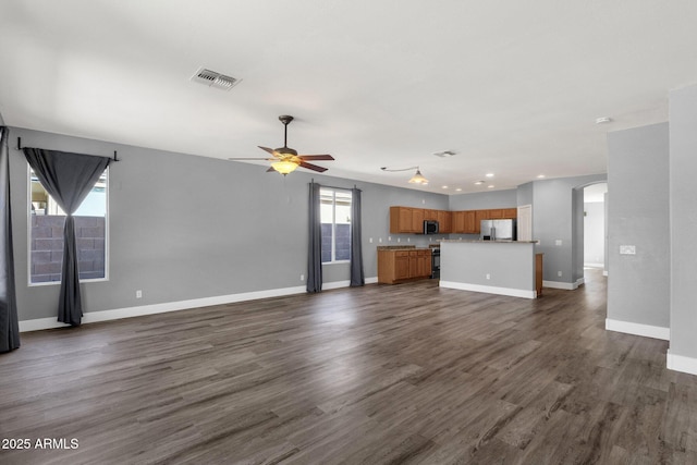21616 E Calle De Flores, Queen Creek, AZ 85142 - unfurnished living room with arched walkways, dark wood-style flooring, baseboards, visible vents, and a ceiling fan