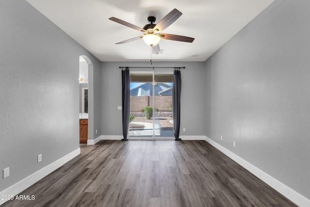 21616 E Calle De Flores, Queen Creek, AZ 85142 - empty room featuring dark wood-style flooring, a ceiling fan, visible vents, baseboards, and arched walkways