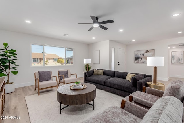 living room featuring ceiling fan and light wood-type flooring