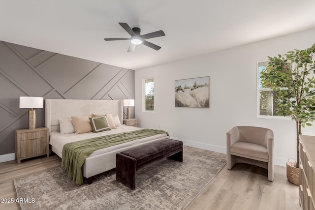 bedroom with ceiling fan and light wood-type flooring