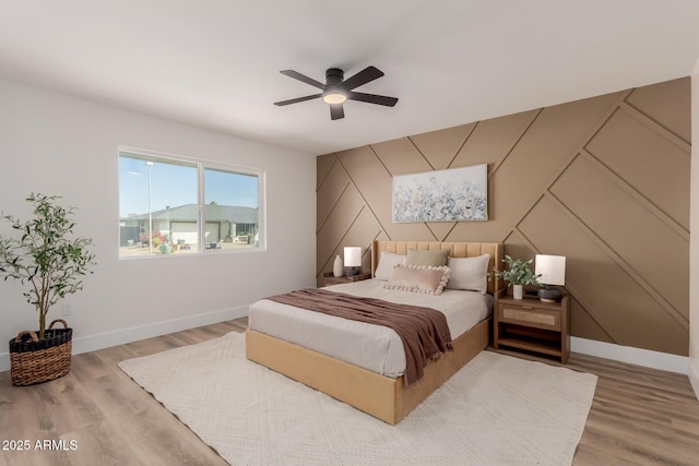 bedroom with wood-type flooring and ceiling fan