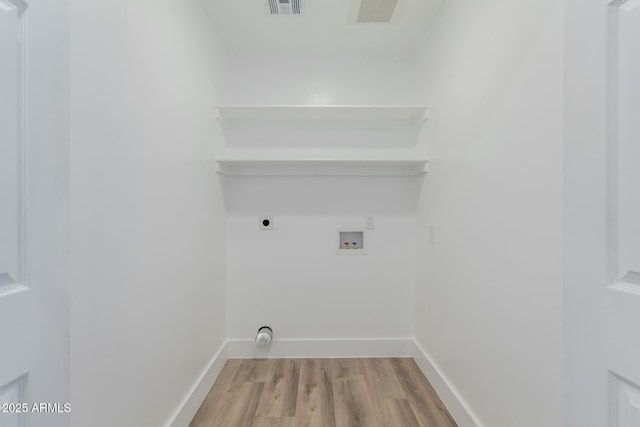 washroom with hookup for an electric dryer, hookup for a washing machine, and light hardwood / wood-style flooring