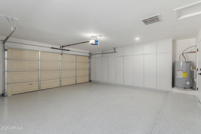 garage featuring a garage door opener and water heater