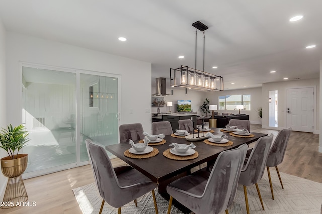 dining space with light hardwood / wood-style flooring