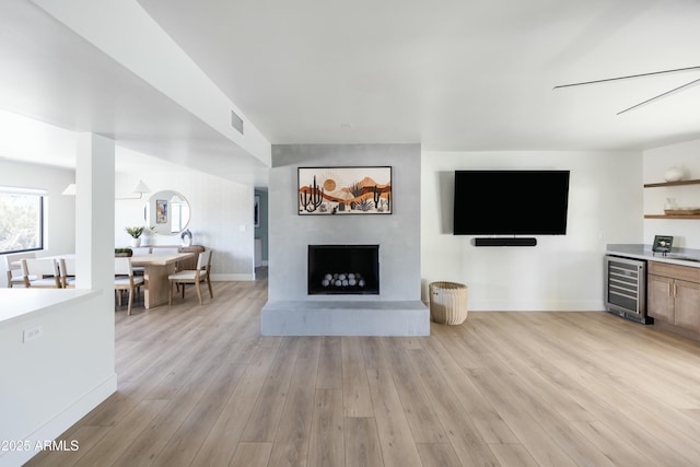 living room featuring light hardwood / wood-style floors and beverage cooler