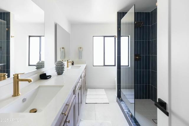 bathroom with tile patterned floors, vanity, an enclosed shower, and a healthy amount of sunlight