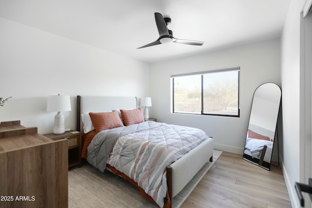 bedroom with light wood-type flooring and ceiling fan