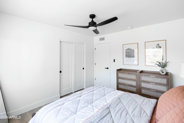 bedroom featuring ceiling fan, hardwood / wood-style flooring, and a closet