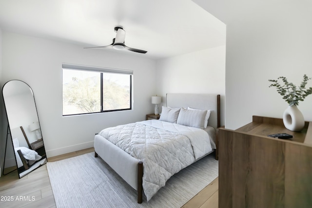 bedroom with ceiling fan and light hardwood / wood-style floors