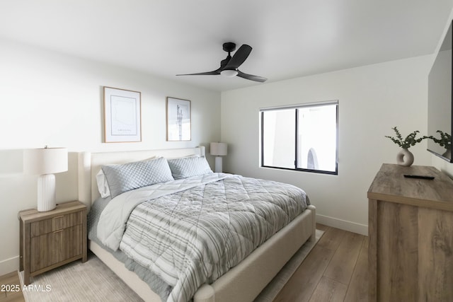 bedroom with ceiling fan and light hardwood / wood-style flooring