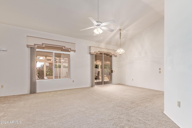 spare room with ceiling fan, carpet floors, and high vaulted ceiling