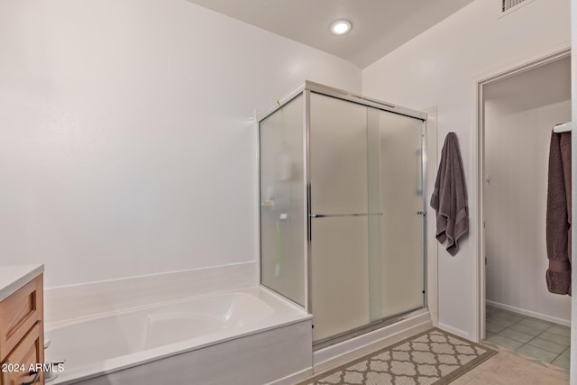 bathroom with tile patterned floors, vanity, and independent shower and bath