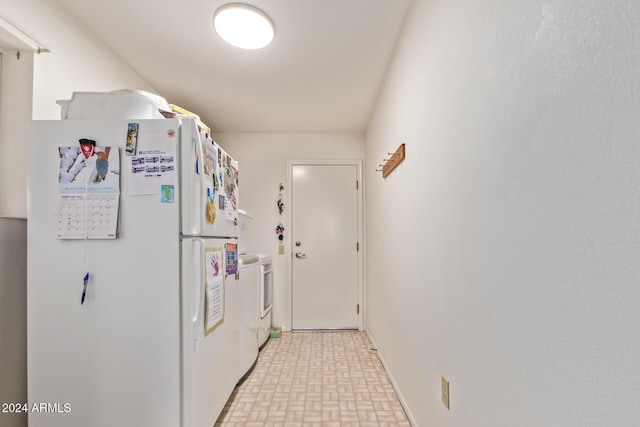 kitchen with washer and dryer and white refrigerator