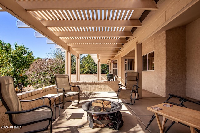 view of patio with a pergola and a fire pit