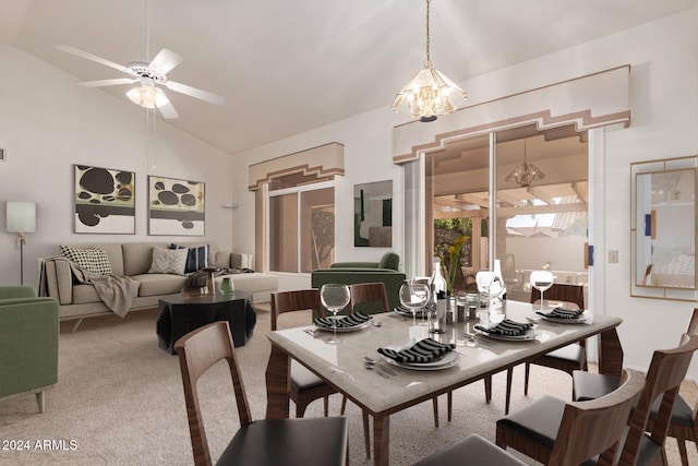 carpeted dining area featuring ceiling fan with notable chandelier and vaulted ceiling