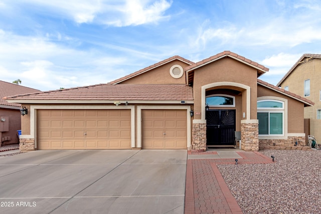 view of front of property featuring a garage, stone siding, and stucco siding