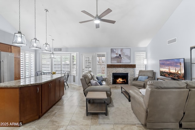 5755 W Harrison St, Chandler, AZ 85226 - living area with a lit fireplace, visible vents, high vaulted ceiling, and a ceiling fan