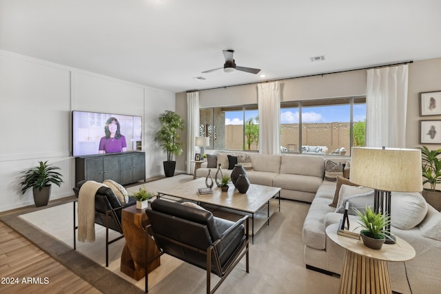 living room featuring ceiling fan and light hardwood / wood-style flooring