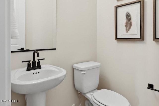 bathroom featuring toilet and sink