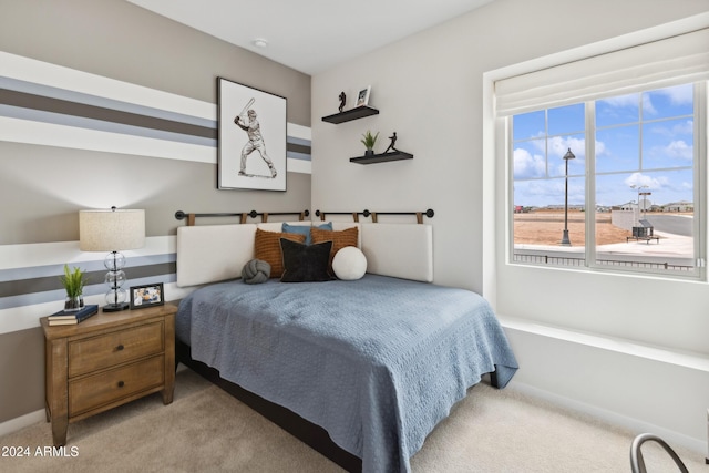 bedroom featuring light carpet