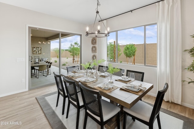 dining room with light hardwood / wood-style flooring, a wealth of natural light, and a notable chandelier