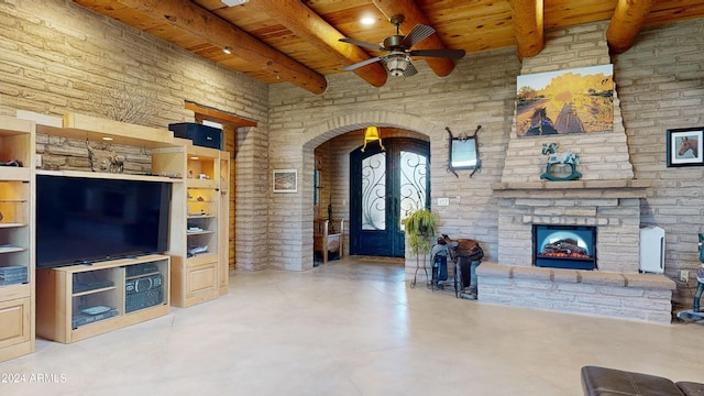 living room featuring french doors, ceiling fan, wood ceiling, built in features, and a fireplace