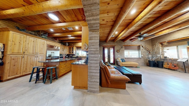 kitchen with wooden ceiling, ceiling fan, brick wall, and a breakfast bar