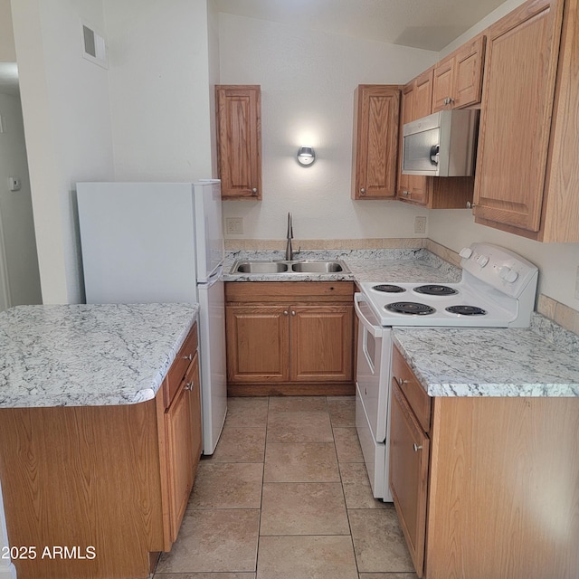 3645 N 69th Ave Unit 99, Phoenix, AZ 85033 - kitchen featuring white appliances and brown cabinets