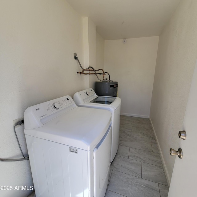 3645 N 69th Ave Unit 99, Phoenix, AZ 85033 - laundry room with electric water heater, washing machine and dryer, and light marble finish flooring