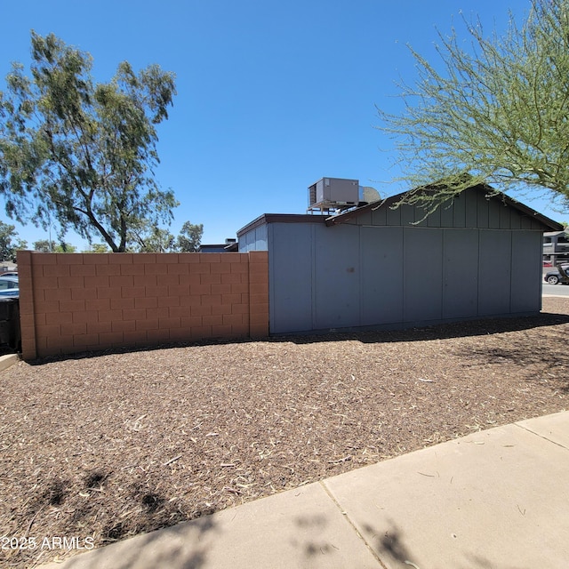 3645 N 69th Ave Unit 99, Phoenix, AZ 85033 - view of property exterior featuring a central air condition unit and board and batten siding