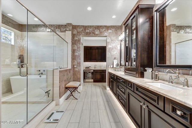 bathroom featuring vanity and separate shower and tub