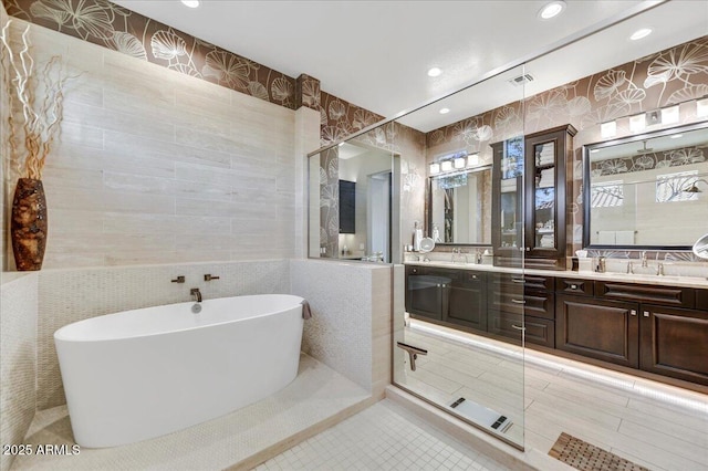 bathroom featuring vanity, shower with separate bathtub, tile patterned flooring, and tile walls