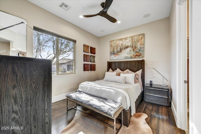 bedroom with dark hardwood / wood-style flooring and ceiling fan