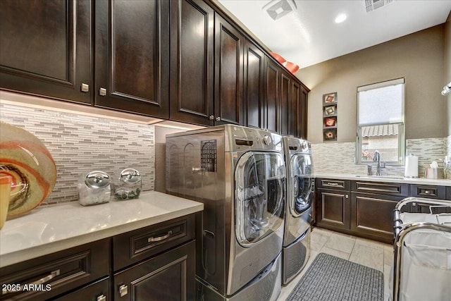 laundry room with sink, cabinets, and washing machine and clothes dryer