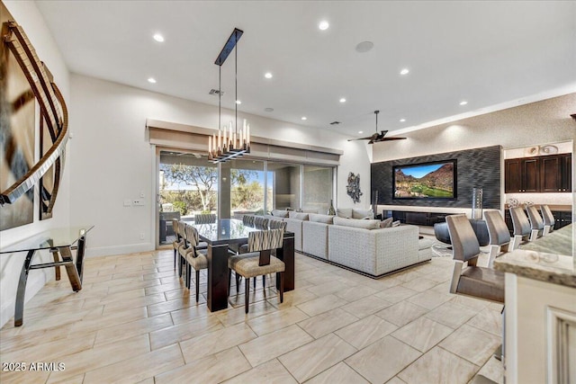 dining space featuring ceiling fan with notable chandelier