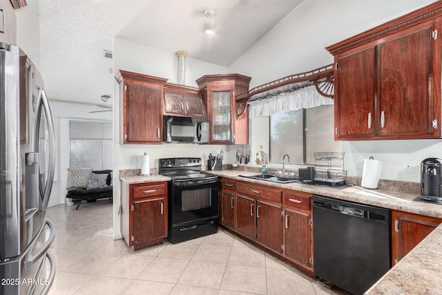 kitchen with light tile patterned floors, vaulted ceiling, a textured ceiling, black appliances, and sink