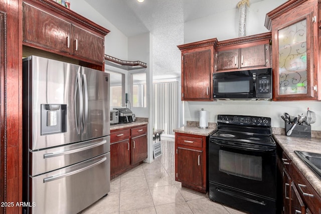 kitchen with black appliances and light tile patterned floors