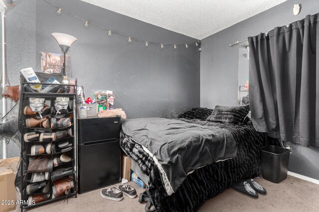 bedroom with carpet floors and a textured ceiling