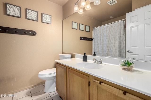 bathroom featuring toilet, vanity, and tile patterned flooring