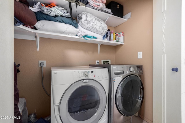 washroom featuring washer and clothes dryer