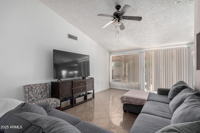 tiled living room with ceiling fan and lofted ceiling