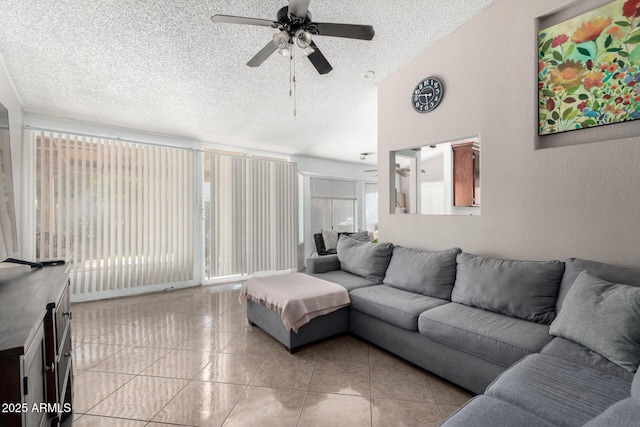 tiled living room featuring ceiling fan and a textured ceiling