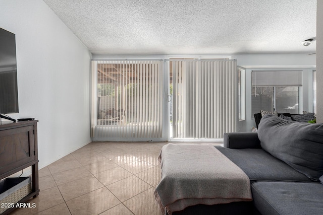 living room with a textured ceiling and light tile patterned floors