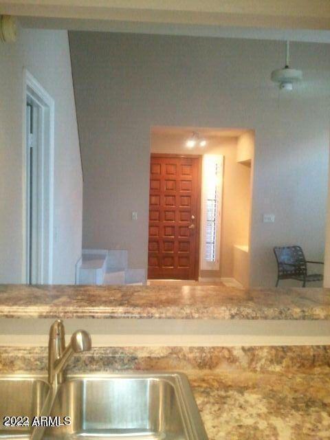 kitchen featuring light stone countertops and sink