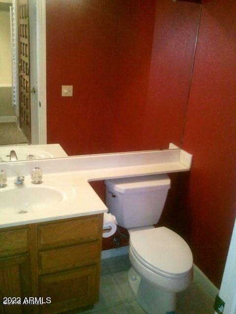 bathroom featuring tile patterned floors, vanity, and toilet